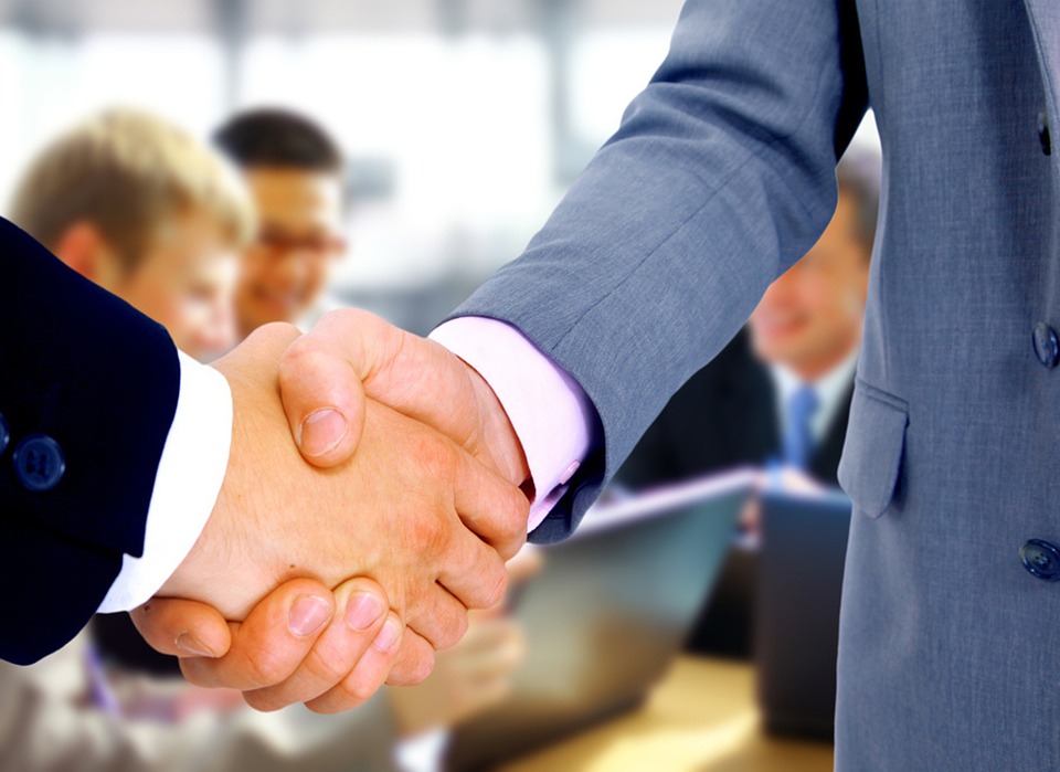 Two people shaking hands, symbolizing partnership in financial services